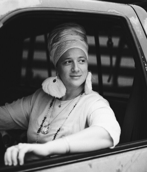 Black and white photo fo Guru Jagat sitting inside a vintage car in NYC
